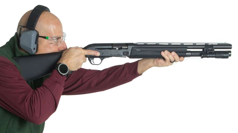 man aiming shotgun
