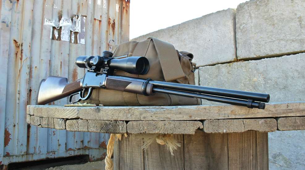 scoped lever action rifle facing right