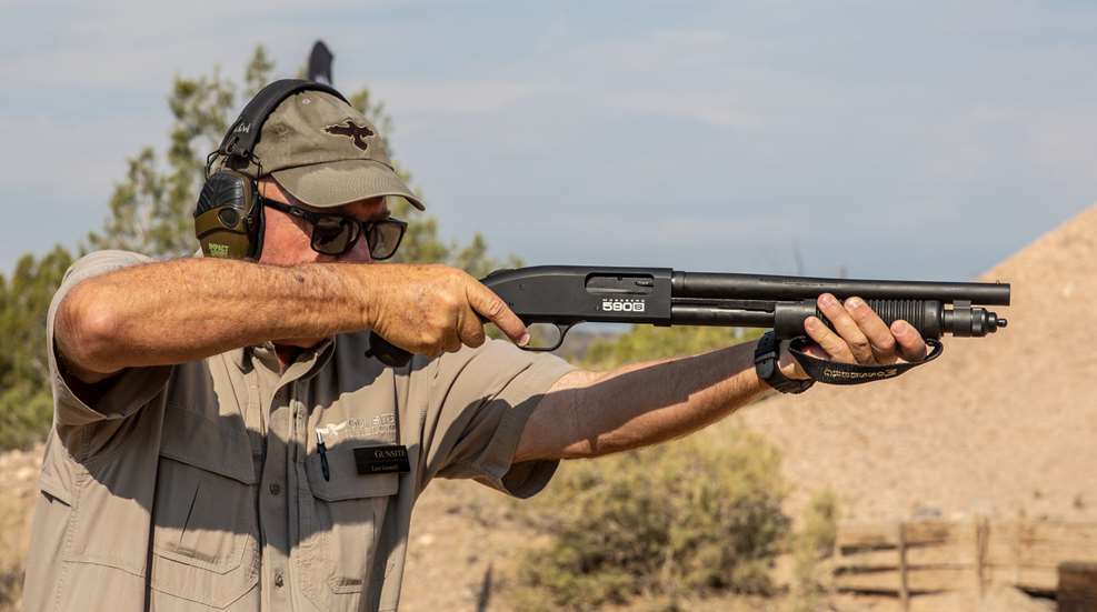 Man on range shooting firearm