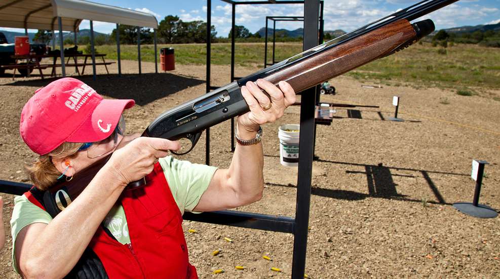 woman shooting shotgun