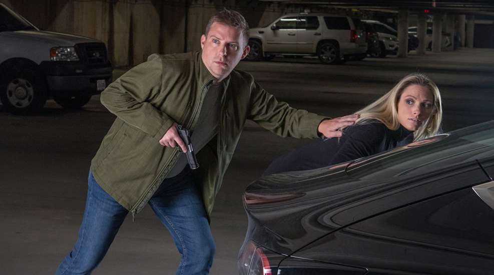 man with firearm protecting woman