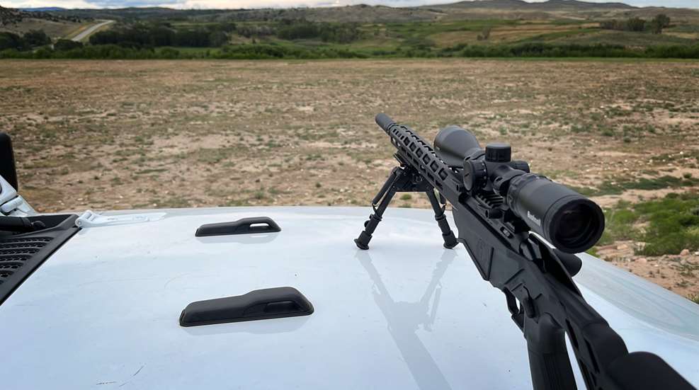 varmint hunting rifle on a truck hood