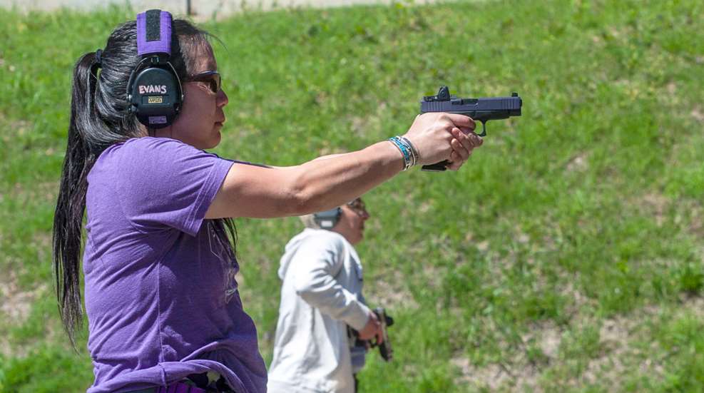woman shooting at range