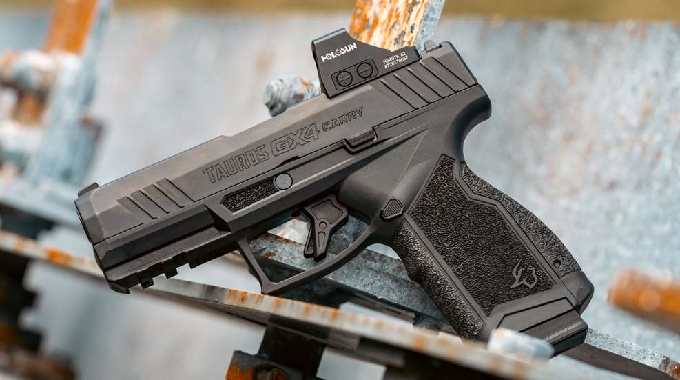 Taurus GX4 Carry 9 mm pistol with Holosun red dot facing left