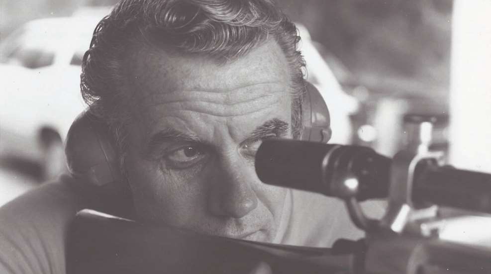 man looking through riflescope
