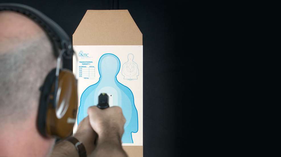 man at gun range
