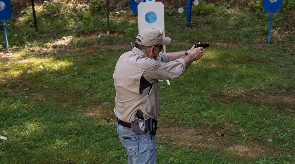 man firing at steel targets