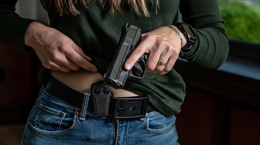 drawing handgun from holster