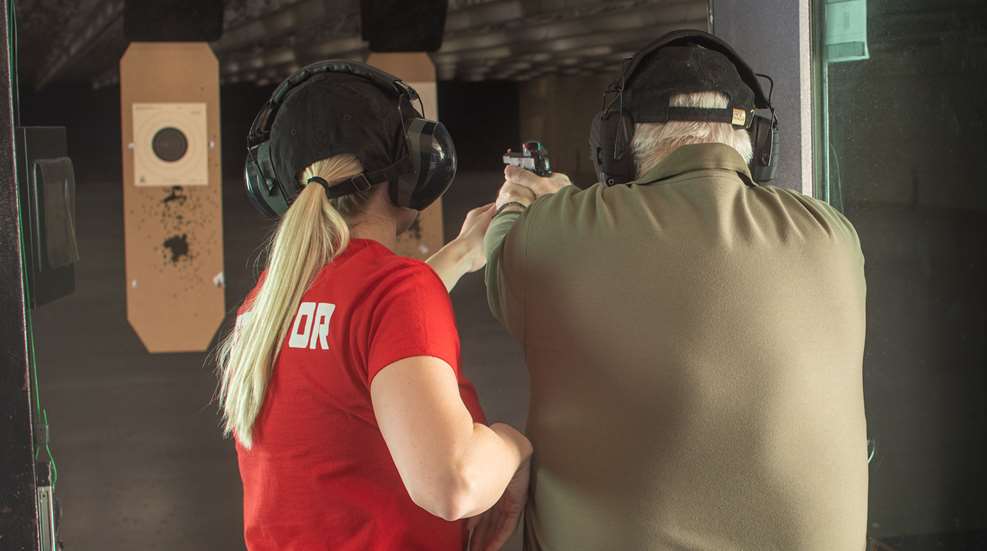 shooter at range with instructor